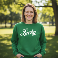 Load image into Gallery viewer, Woman wearing a green sweatshirt with 'Lucky' printed on it, standing in a park.