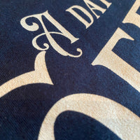 Load image into Gallery viewer, A Day Without Coffee t-shirt design detail in navy